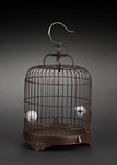 A BAMBOO BIRD CAGE WITH TWO BLUE AND WHITE PORCELAIN FEEDERS