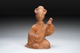 A RED CLAY POTTERY FIGURE OF A LADY MUSICIAN