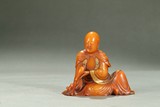 A SHOUSHAN STONE FIGURE OF SEATED LUOHAN 