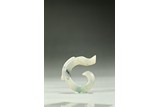 A SMALL ARCHAIC JADE CARVED DRAGON
