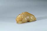 A YELLOW JADE CARVING OF MYTHICAL BEAST
