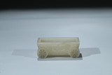 A CELADON JADE CARVED 'TAOTIE' CART-FORM COLLECTOR'S BOX