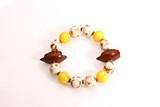 AN AMBER AND PORCELAIN ROSARY BRACELET