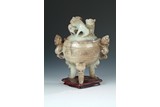 A CARVED 'MYTHICAL BEASTS' JADE TRIPOD CENSER
