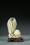 A CHINESE WHITE JADE CARVING OF BUDDHA'S HAND