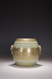A CHINESE CELADON AND GILT DRUM SHAPED JAR