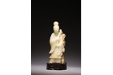 A CHINESE WHITE AND RUSSET JADE FIGURE 