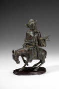 A Chinese carved bronze figure of a man riding a donkey