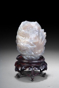 A small Chinese scholar rock, with a wood base.