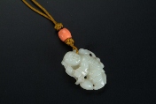 A Chinese carved jade ornament of a boy