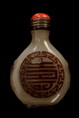 A WELL CARVED WHITE JADE SNUFF BOTTLE