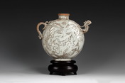 A FLATTENED SHAPE TEAPOT WITH IMPRESSED DRAGON PATTERN