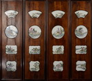 A SET OF FOUR WOOD FRAMED HANGING FAMILLE ROSE PORCELAIN PANELS