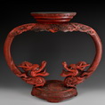A LACQUER WOOD CARVED DRAGONS STAND
