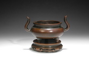 A BRONZE CENSER WITH RISING HANDLES