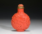 A CARVED CORAL GLAZED SNUFF BOTTLE