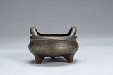 A Chinese bronze tripod censer