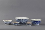 A group of five blue and white bowls