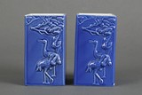 A pair of blue glazed square bottles