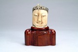 A Chinese carved ivory Buddha head statue