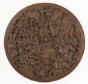 A wooden carved battle scene round plaque