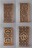 A group of four wood carved hanging panels