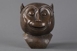 A bronze monkey head statue