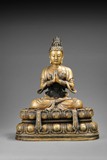 A GILT BRONZE FIGURE OF SEATED GUANYIN