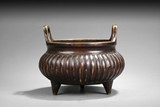 A BRONZE TRIPOD CENSER