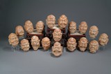 A SET OF CARVED PORCELAIN EIGHTEEN ARHAT HEADS