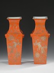 A PAIR OF GILT DECORATED ORANGE GLAZED VASES