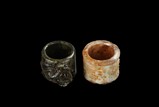 TWO CARVED JADE THUMB RINGS