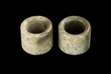 A PAIR OF JADE STONE THUMB RINGS