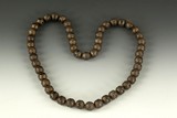 A STRAND OF AGATE BEADS WITH SILVER COVER