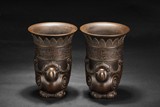 A PAIR OF IRON BIRD SHAPED VESSELS
