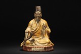 A PORCELAIN SEATED WONG TAI SIN STATUE