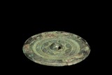 AN ARCHAIC BRONZE 'SUN' MIRROR