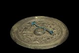 A BRONZE 'INSCRIPTIONS AND BEASTS' MIRROR 