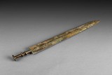 AN ARCHAIC BRONZE SWORD