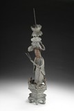 A CHINESE TAOIST FIGURE PEWTER CANDLESTICK HOLDER