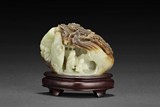 A PIERCE CARVED WHITE JADE SHANZI