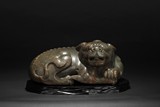 A CELADON JADE LION CARVING