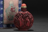 A CARVED CINNABAR LACQUER SNUFF BOTTLE WITH BOX
