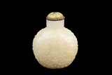 A CARVED WHITE JADE SNUFF BOTTLE