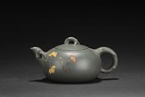 A GREEN CLAY 'BUTTERFLIES AND FLOWERS' TEAPOT