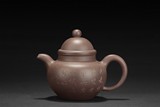 A PURPLE CLAY TEAPOT