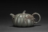 A GREEN CLAY 'PUMPKIN' TEAPOT