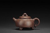 A PURPLE CLAY TEAPOT
