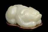 A WHITE JADE CARVING OF MYTHICAL BEAST