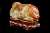 A WHITE JADE CARVING OF MYTHICAL BEAST FIGURE
